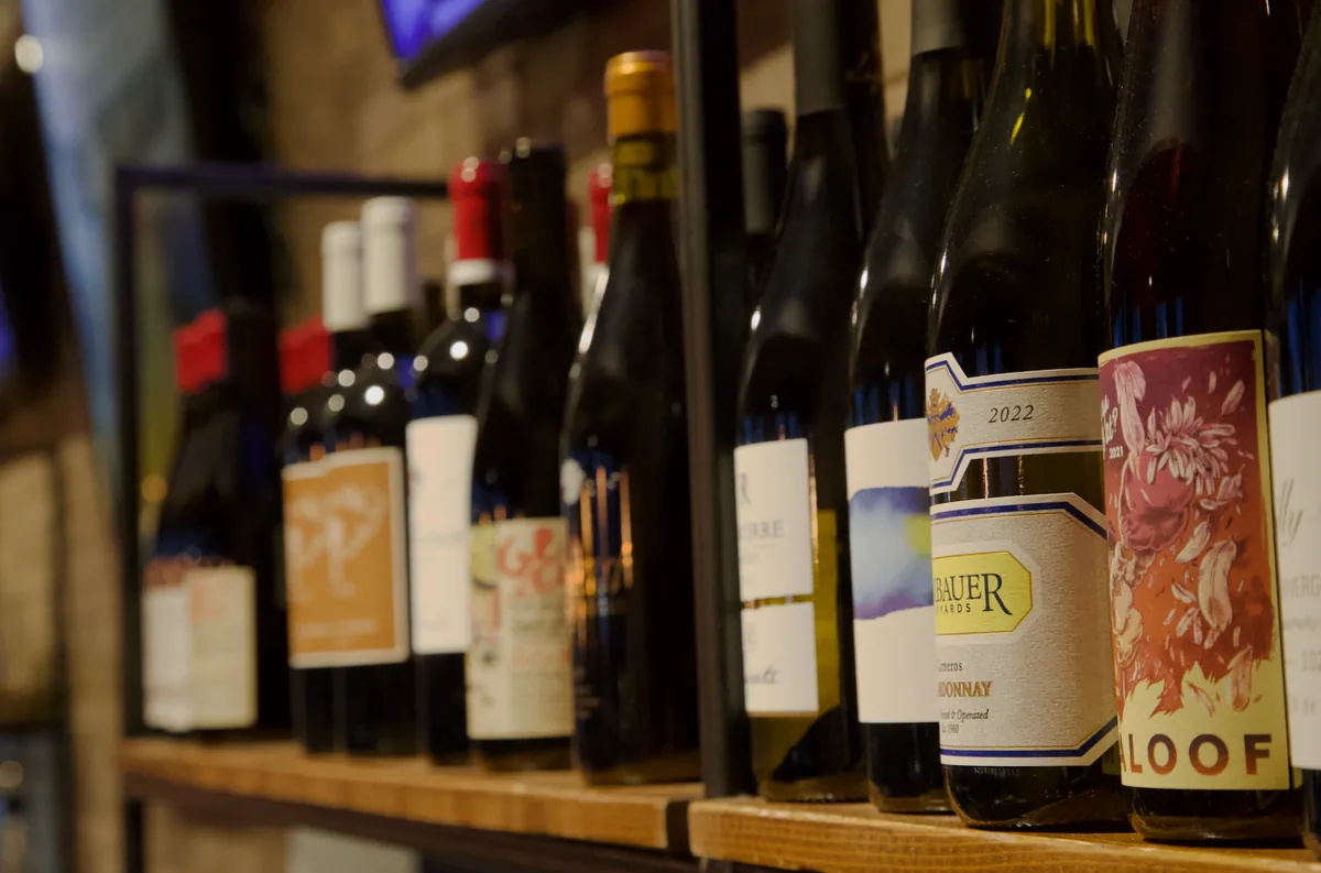 Wine bottles displayed on wooden shelves